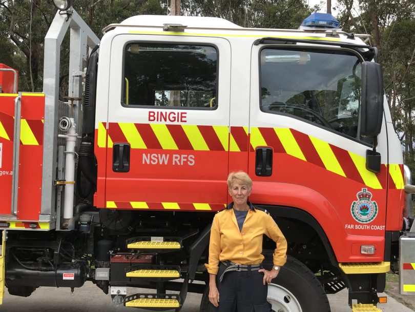 Professor Miriam Baltuck standing in front of a firetruck