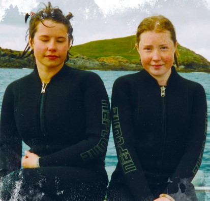 Two girls in wetsuits