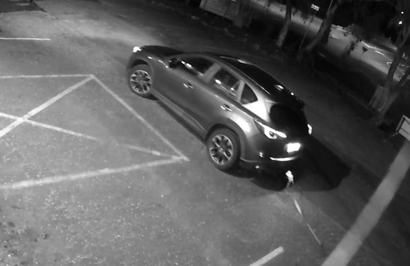 black and white security footage of car