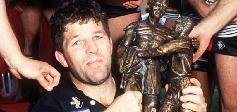 A young rugby legend Royce Simmons clutching trophy