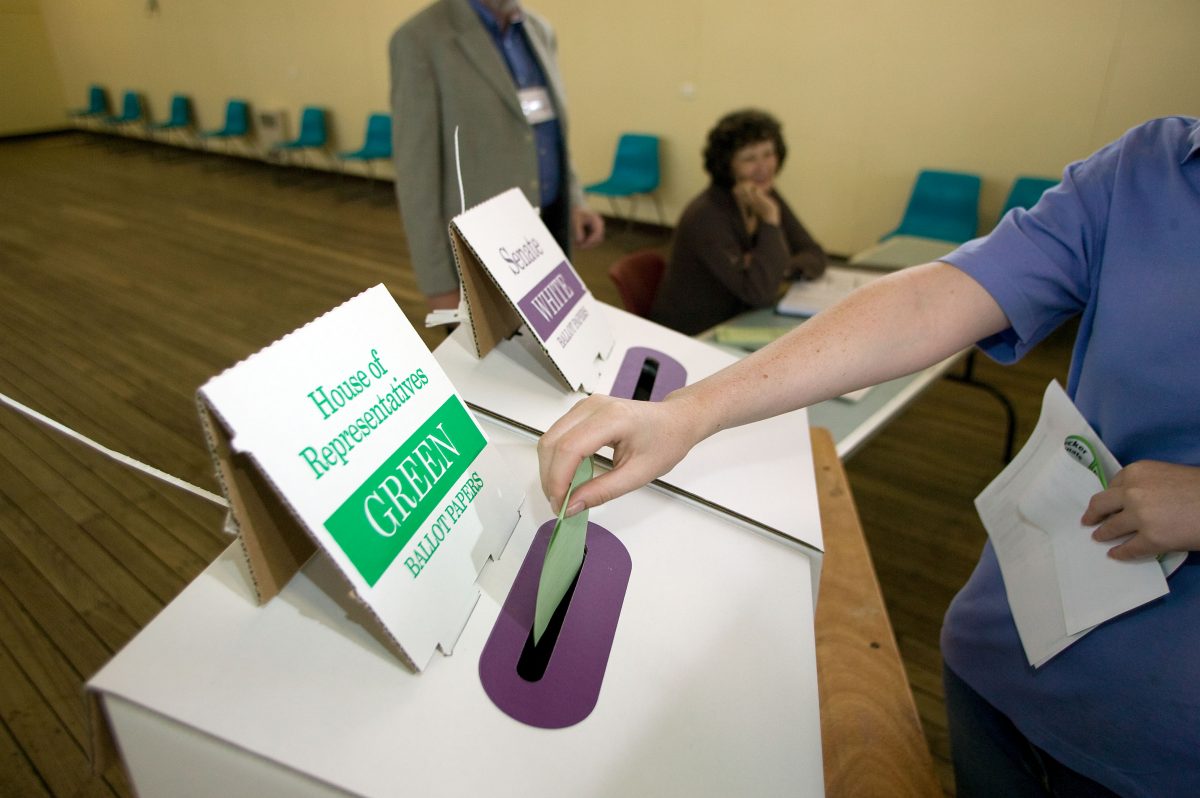 Person casting vote at a ballot box