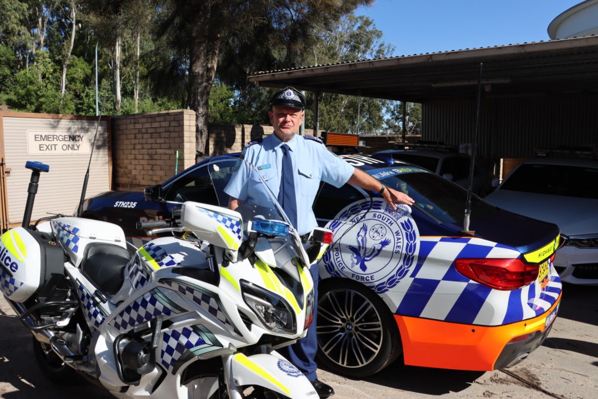 Former Senior Constable Mark Dawes with police vehicles