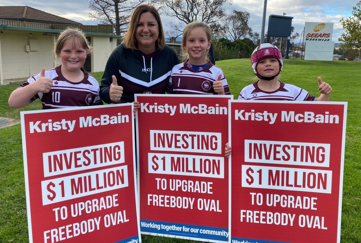Kristy McBain with kids holding pledge signs