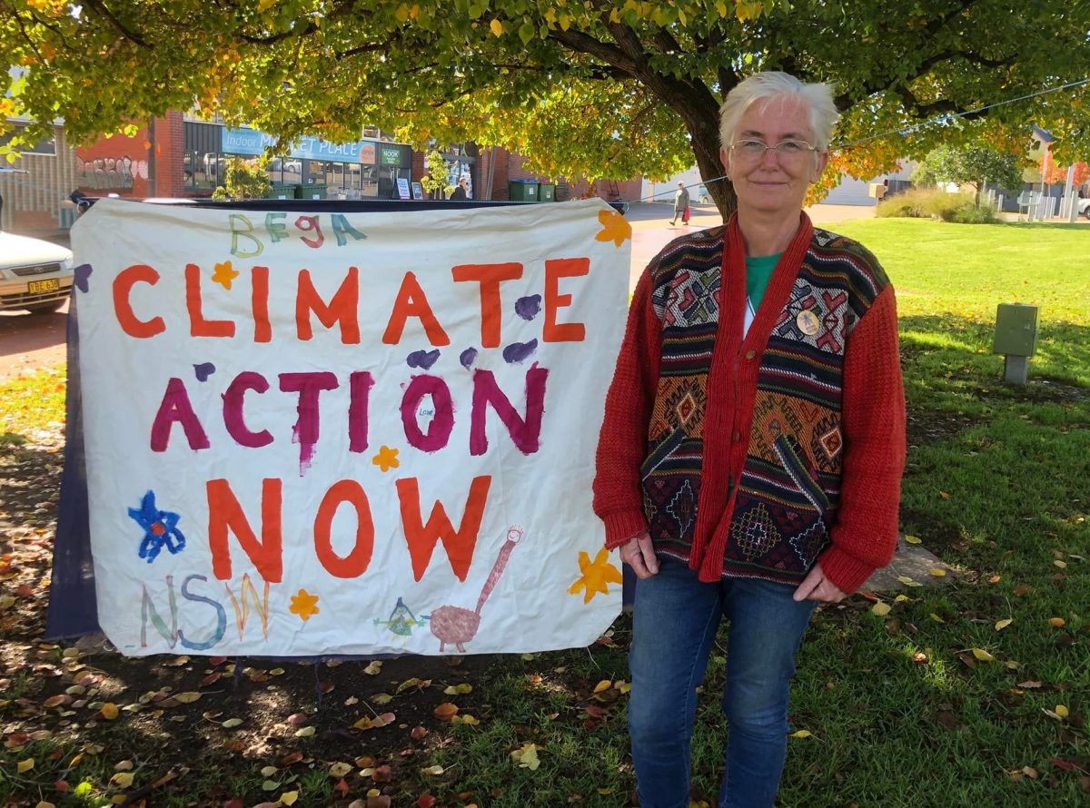 Vivian Harris in front of climate action banner