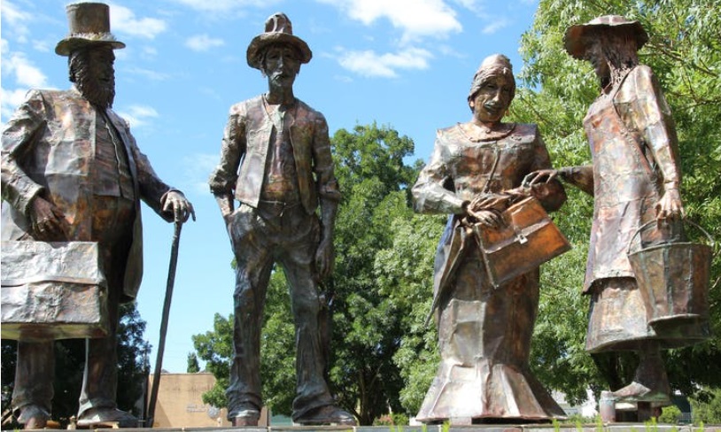 Four copper statues of people