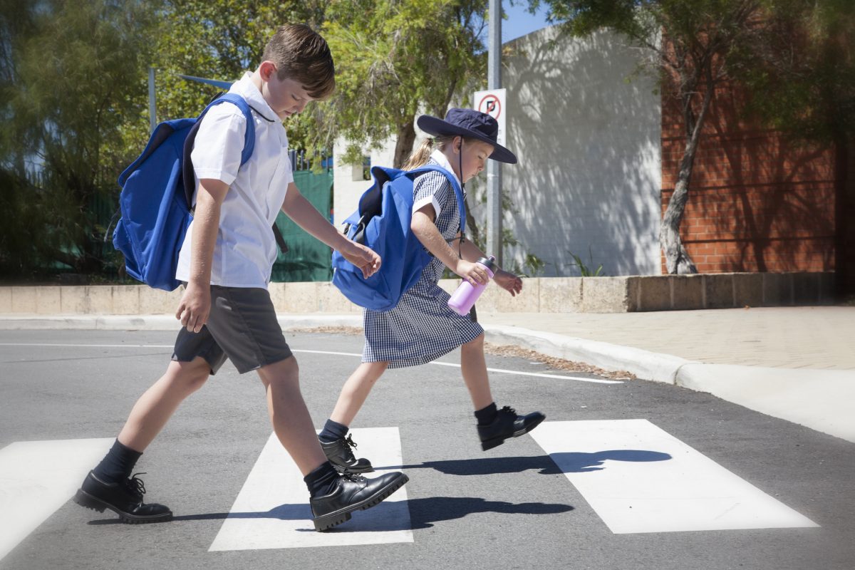 School children crossing pedestrian crossing