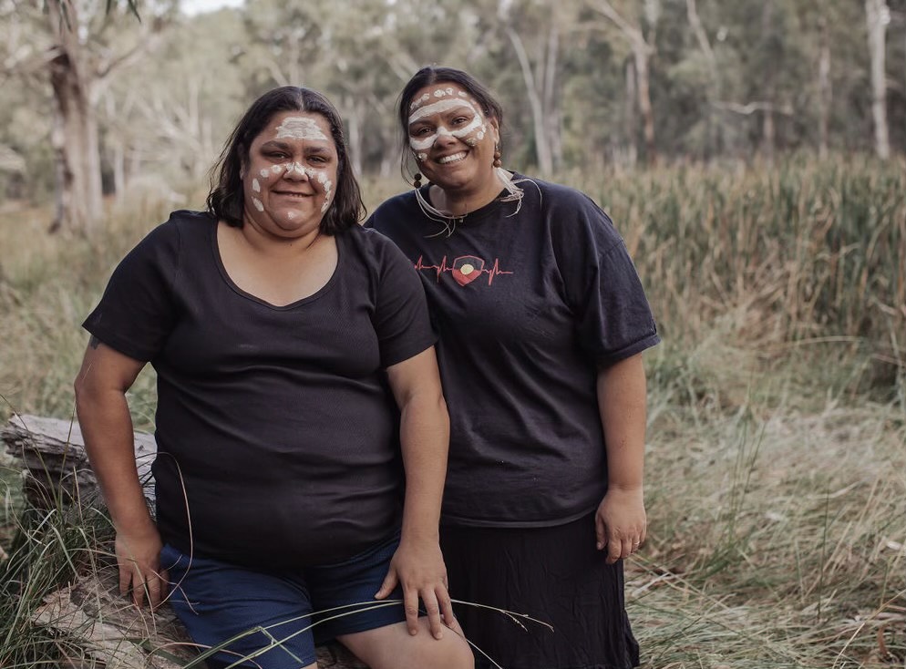 Two aboriginal women wearing ochre