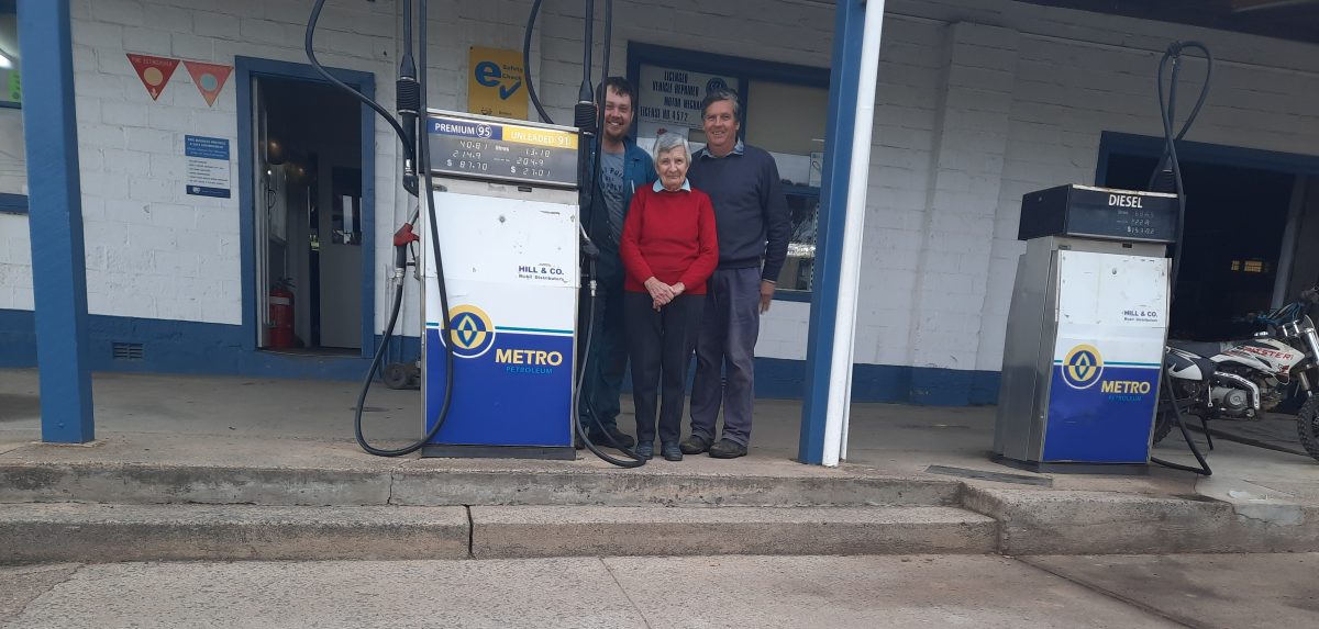 Two men and a woman at a petrol station