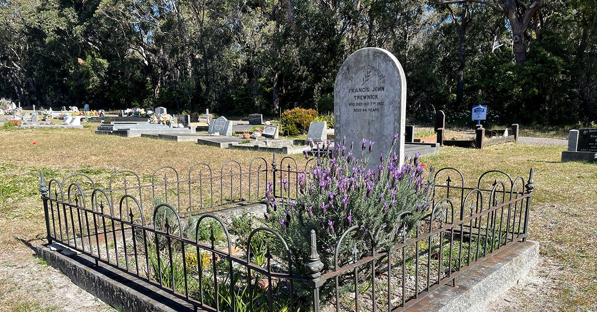 Tombstone and grave in cemetery