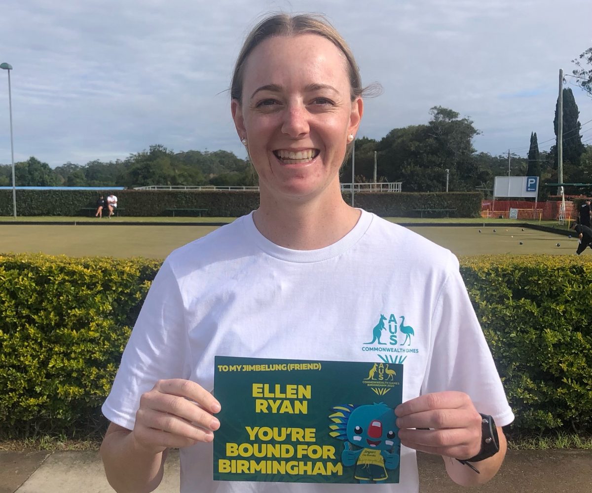 Lawn bowler Ellen Ryan holding up an invitation