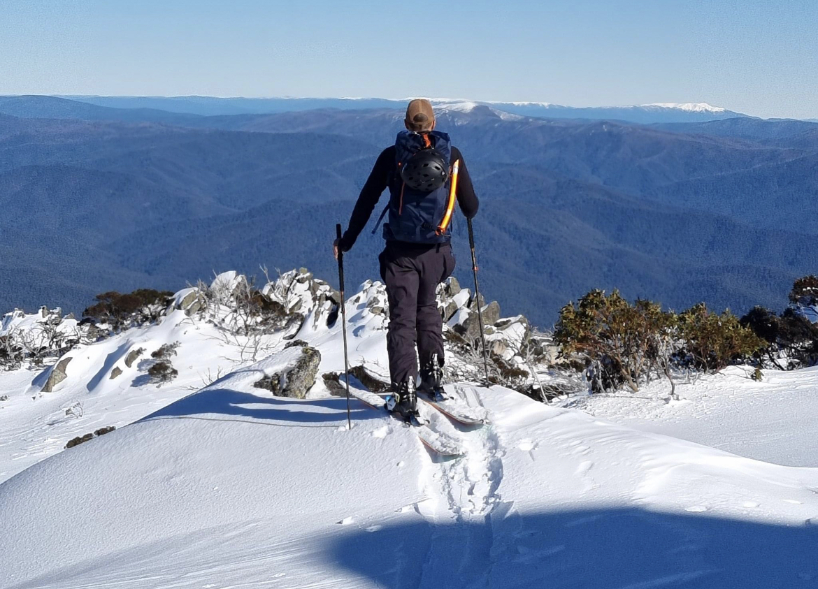 Man standing on alpine precipice 
