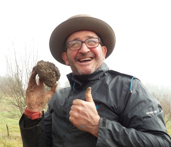 man holding truffle and giving a thumbs up