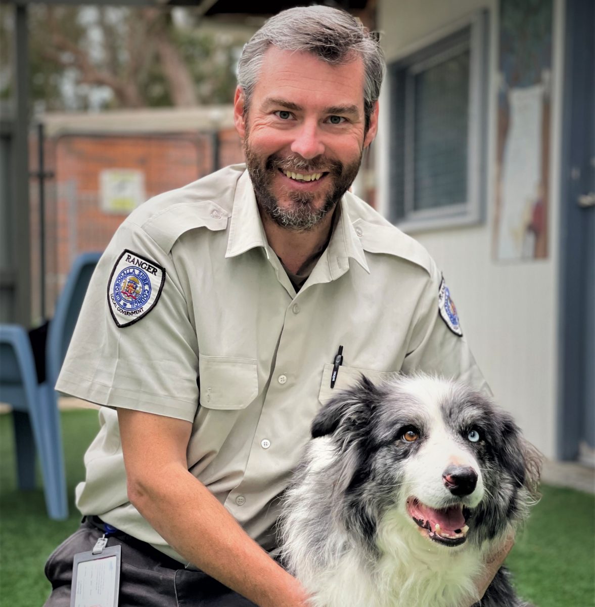 Caption: Ranger Jason Ritzen with a dog