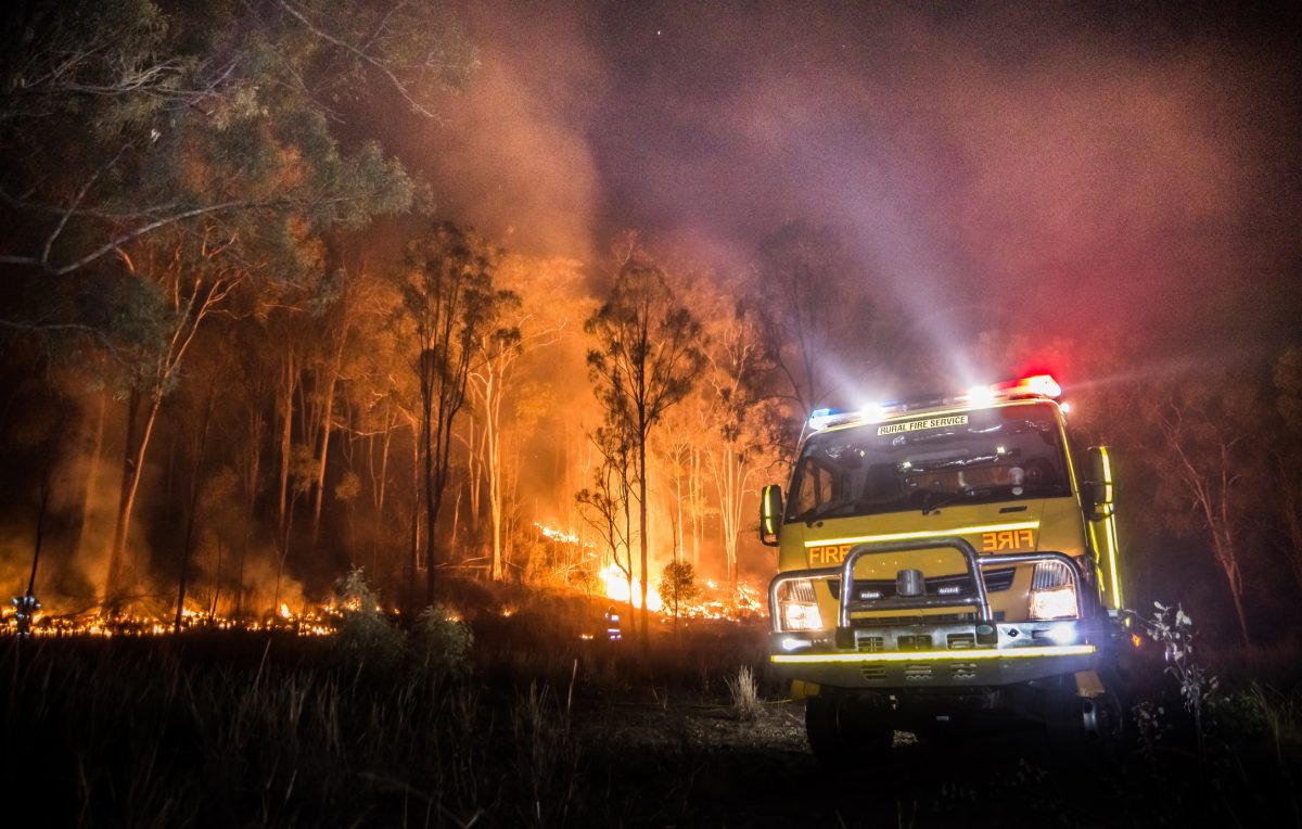 australian rural fire truck in front of bush fire