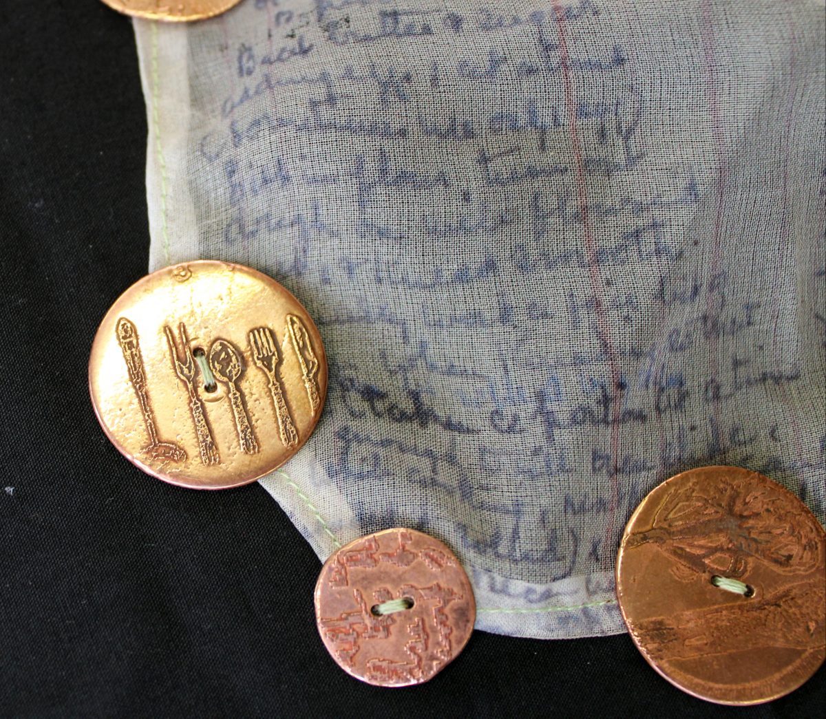 artwork with bronze buttons and fabric