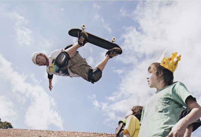 Person doing stunt in air on skateboard