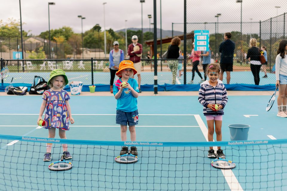 kids holding tennis ball