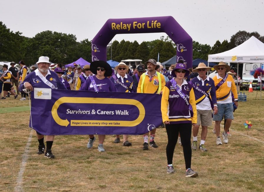 Participants in Relay for Life event hold a banner