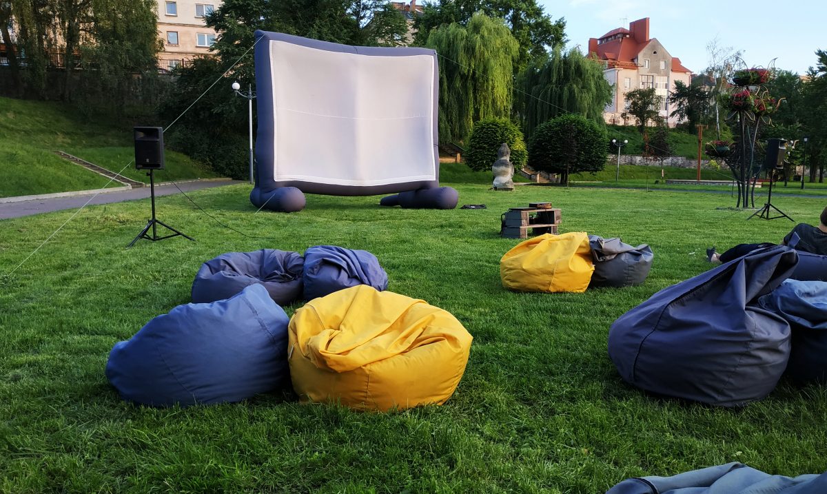 beanbags and a giant projector spread on a lawn for an open-air cinema at Belmore Park