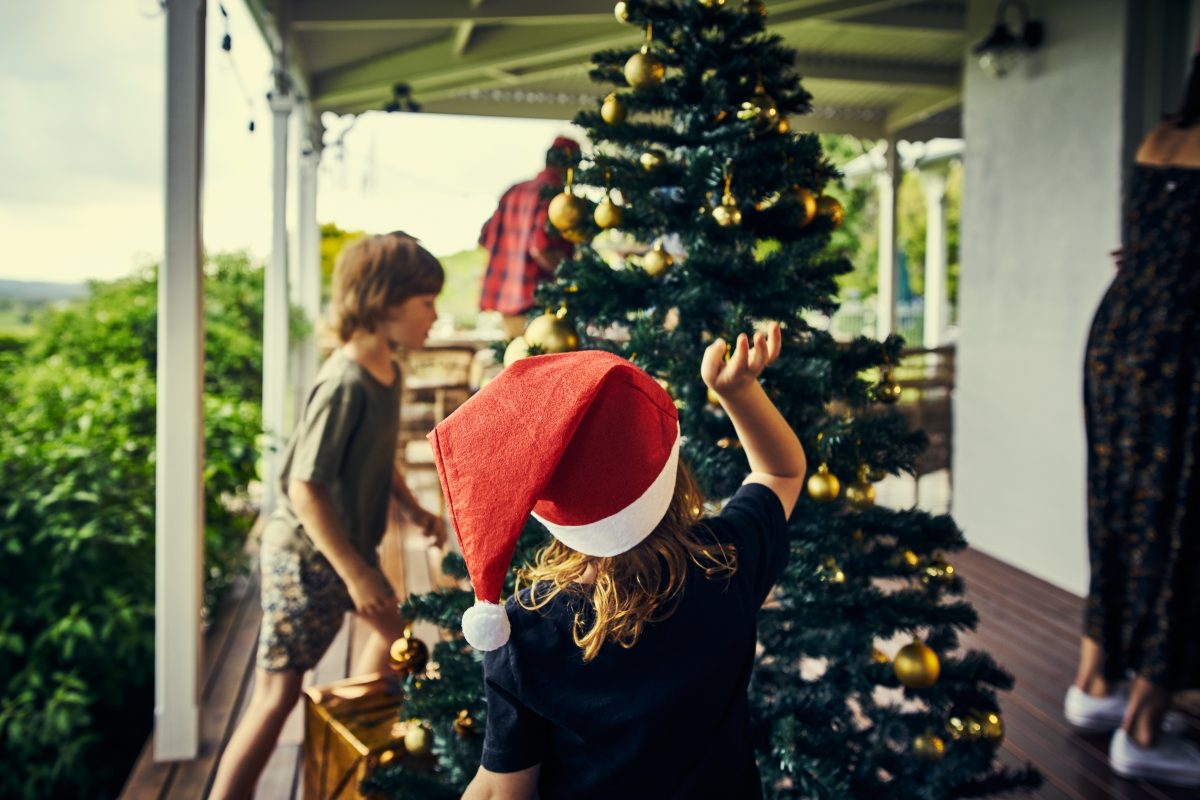  kids decorating a Christmas tree