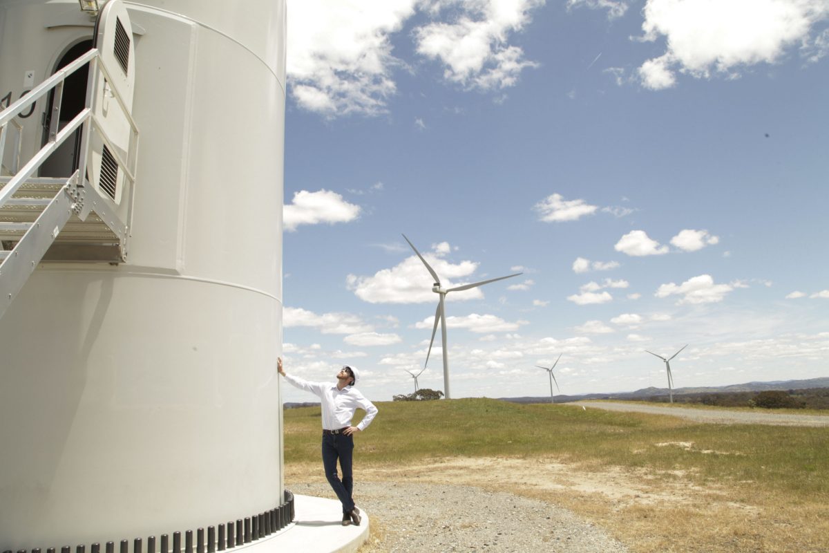 Man and wind farm turbine