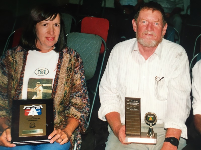 Man and woman with awards