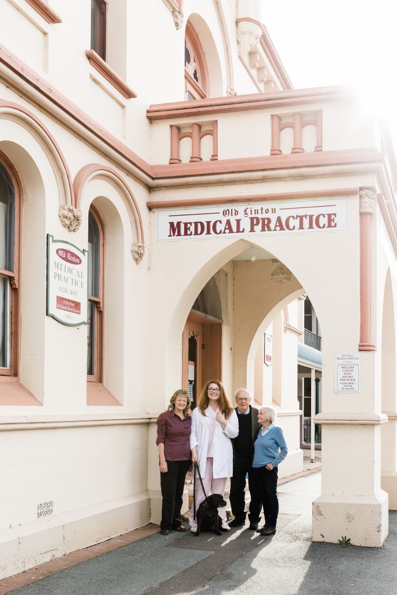 Four people outside medical clinic