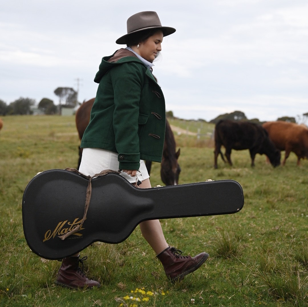 woman with guitar on farm