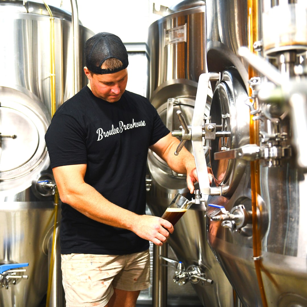 Man working with a beer fermenter
