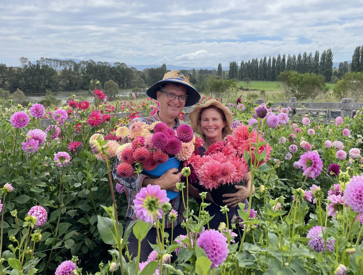 Ali Rodway and Geoffrey Badger surrounded by flowers