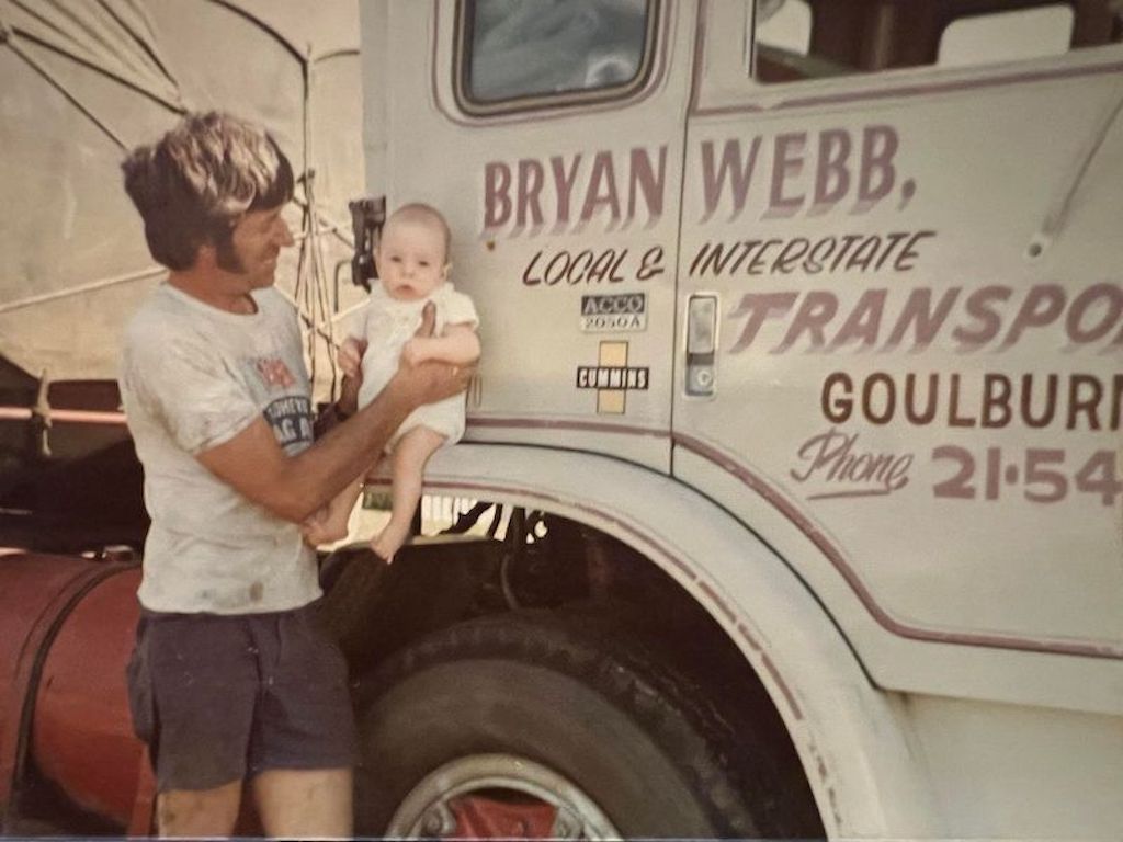 man with baby and truck