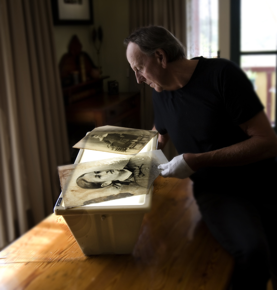 Man looks at photos on a light box