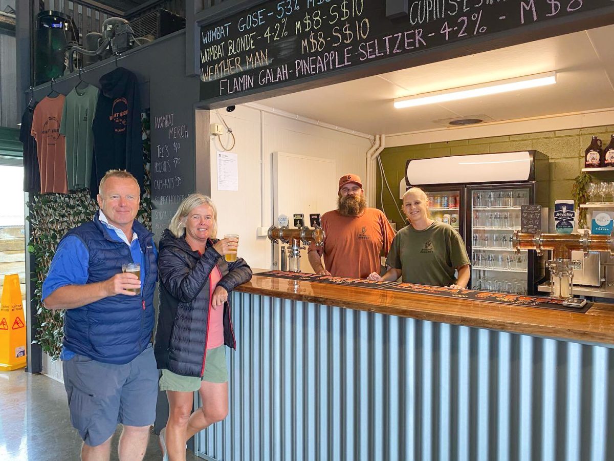 Wombat Brewery owner standing with staff member and two customers