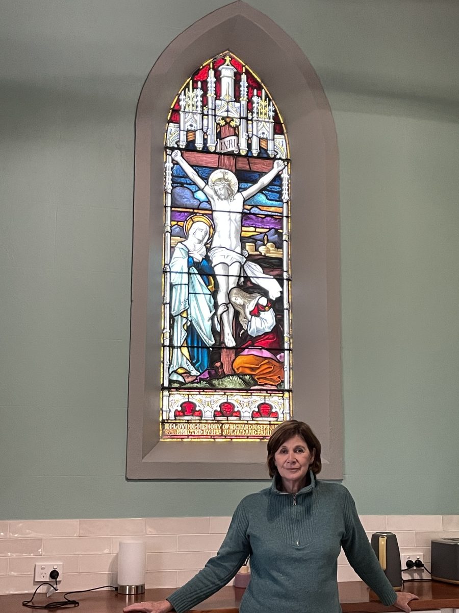 Woman in front of stained-glass window