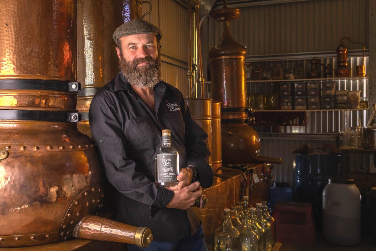 Master distiller Gavin Hughes with North of Eden's beloved copper alembic stills. Photo: David Rogers