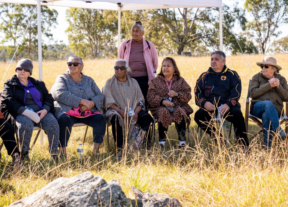 Indigenous elders sitting under a gazebo