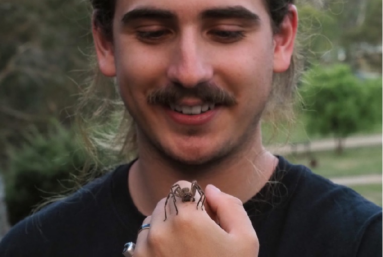 man holding a spider on his hand