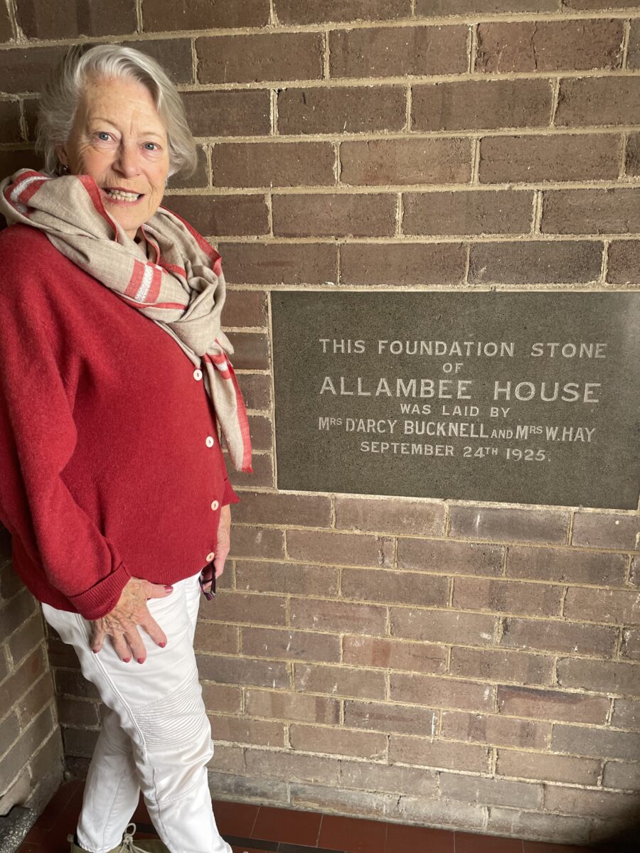 Woman next to plaque 