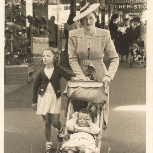 Mother with toddler daughter, and son in pram