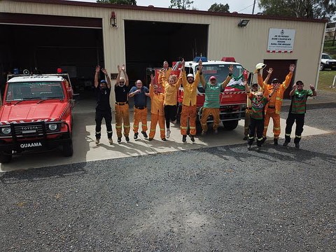 A group of men standing next to fire vehicles