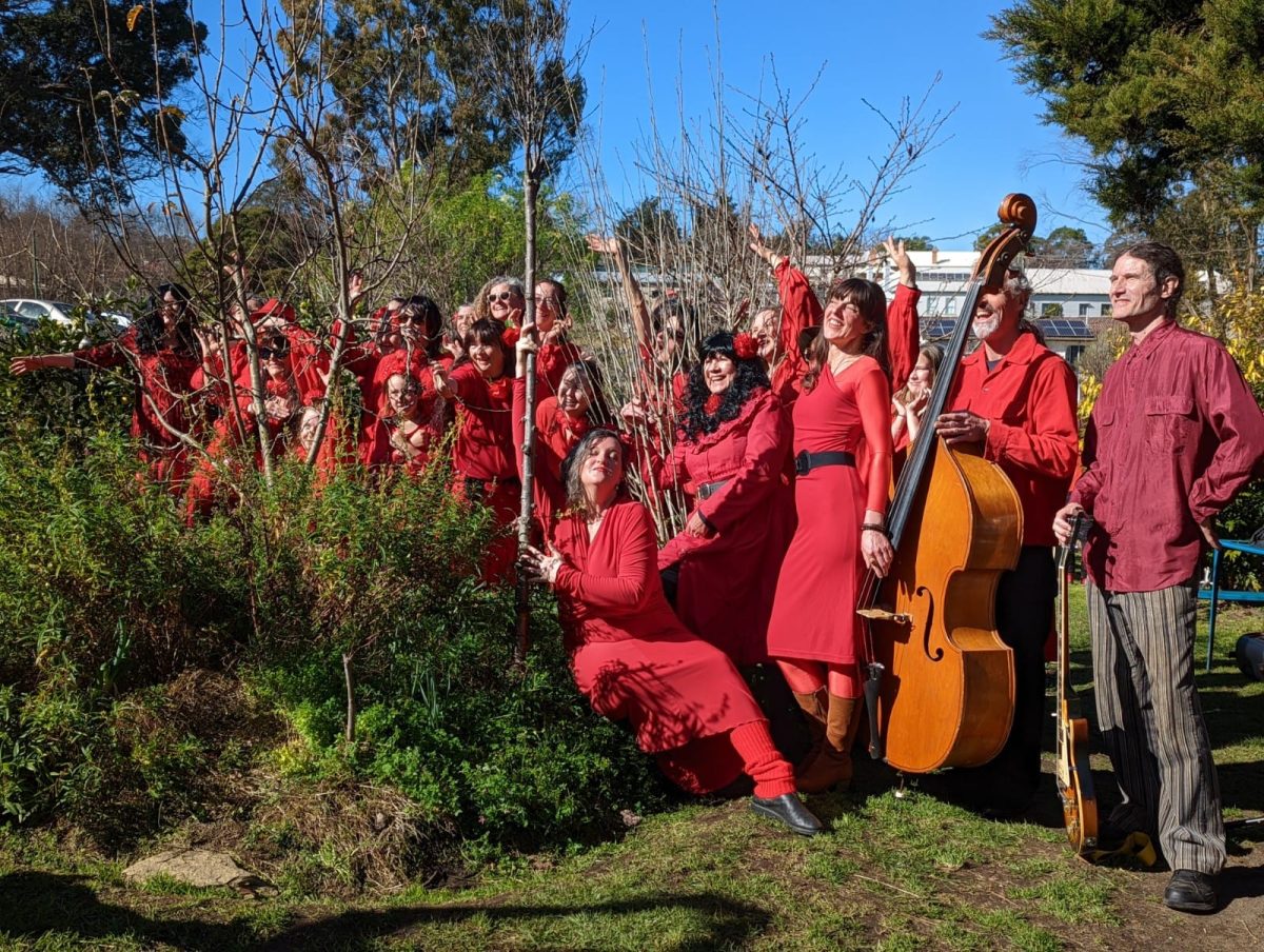 A group of smiling people in red clothing