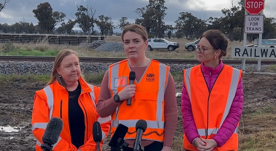 Jennie Aitchison, Maddie Bott and Steph Cook standing at railway crossing