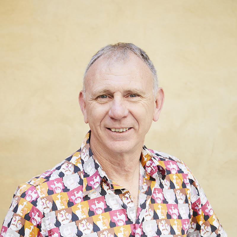 A photograph of Andrew Gray in a brightly patterned shirt
