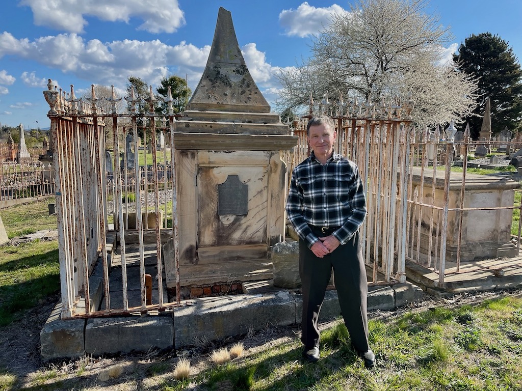 man in front of grave