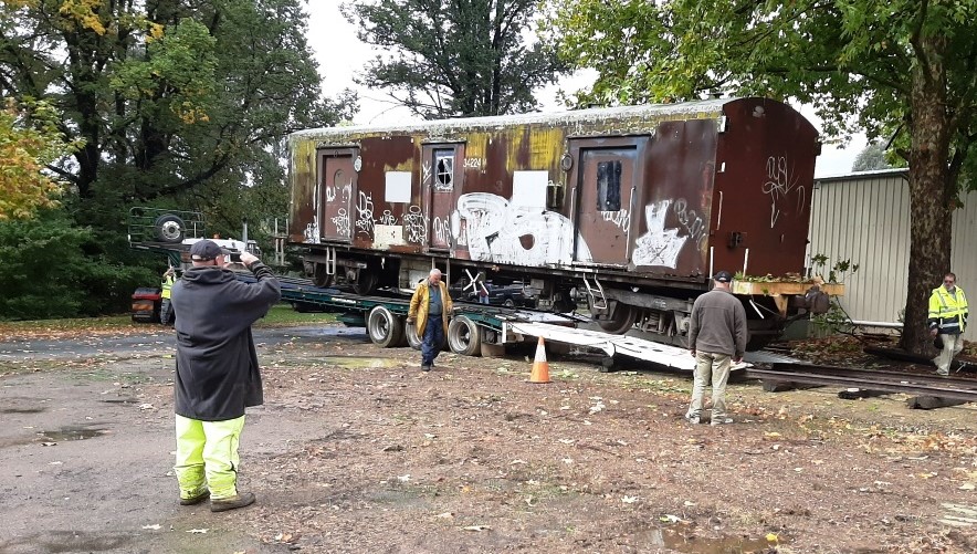 men with restored train guards' carriage