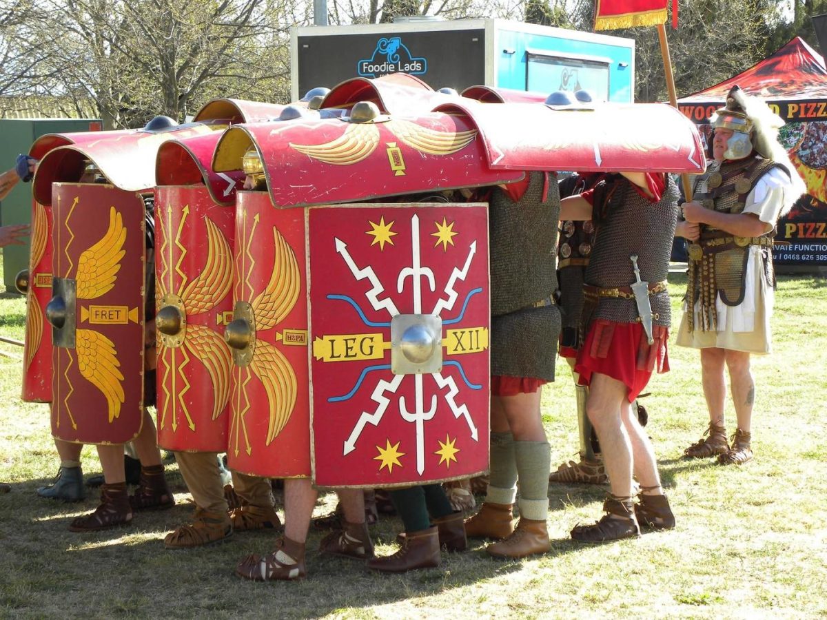 People standing under or behind shields