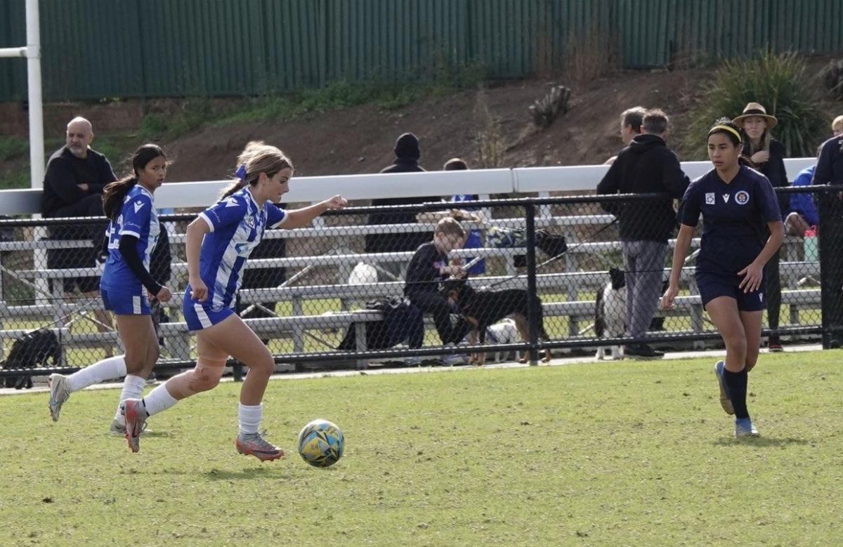 soccer player dribbling during a game