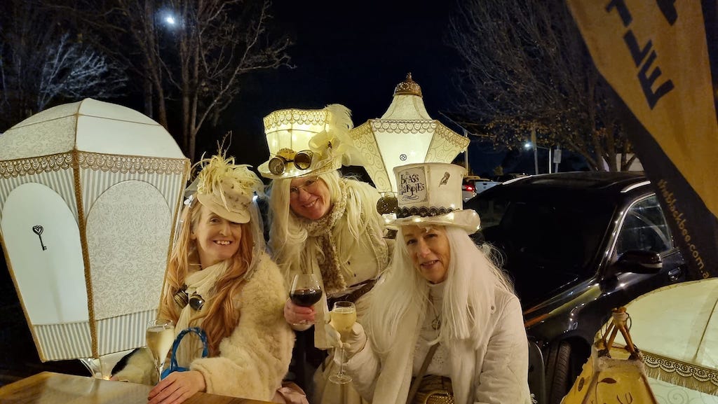 three women in fancy dress costumes