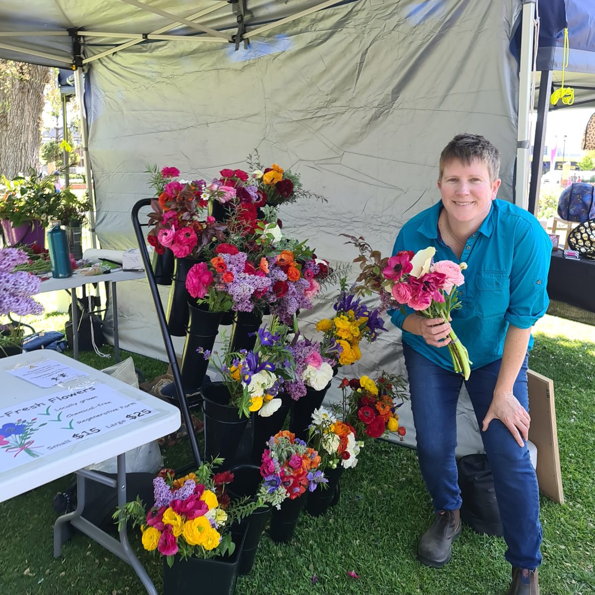 A woman next to a stand of bouquets 