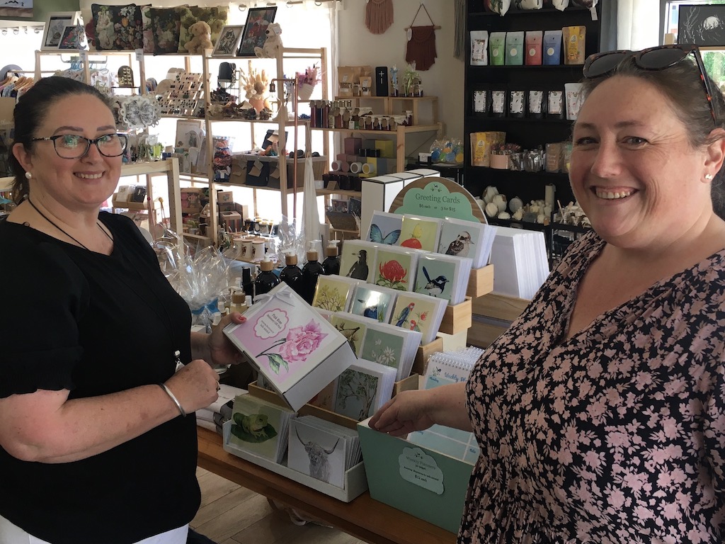 two women in shop of handmade products such as gift cards